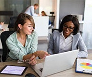 two women looking at a computer